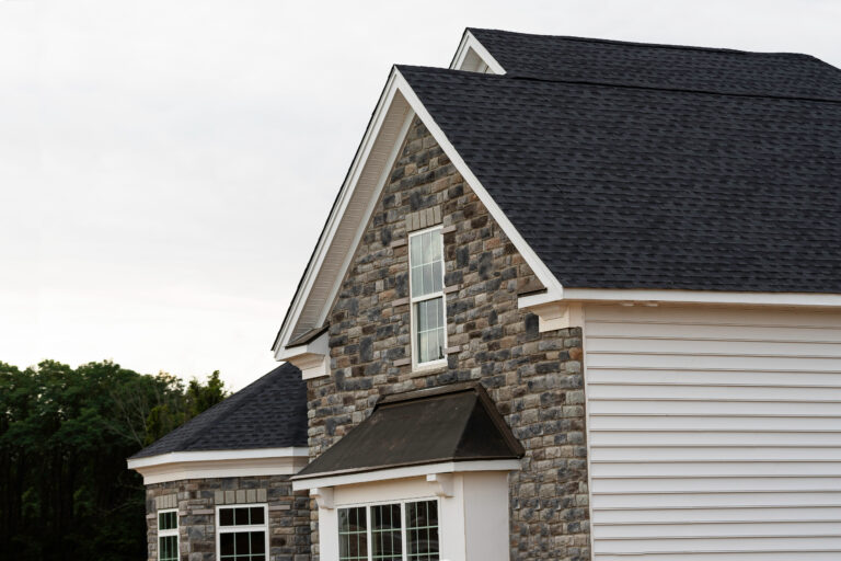 edge of roof shingles on top of the house dark asphalt tiles on the roof background color